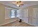 Bedroom with modern ceiling fan, window alcove, and wood-look vinyl floors at 13495 Newport Ave, Port Charlotte, FL 33981