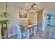 Cozy dining room with a wooden table, two chairs, and a corner cabinet at 13495 Newport Ave, Port Charlotte, FL 33981