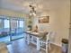 Cozy dining room with a wooden table, two chairs, and sliding glass doors to a screened-in porch at 13495 Newport Ave, Port Charlotte, FL 33981
