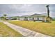 Charming one-story home with a metal roof, a well-manicured lawn and an attached one-car garage at 13495 Newport Ave, Port Charlotte, FL 33981