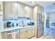 Beautiful kitchen with stainless steel appliances, updated cabinets, marble countertops and subway tile backsplash at 13495 Newport Ave, Port Charlotte, FL 33981