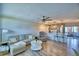 Open-concept living room and kitchen with wood floors, modern furniture, and pendant lighting at 13495 Newport Ave, Port Charlotte, FL 33981