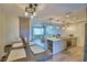 Open floorplan dining and living area featuring modern lighting, flooring, and stainless steel appliances at 13495 Newport Ave, Port Charlotte, FL 33981