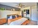 Bright main bedroom features modern floors, a closet, sliding glass door, fan, and a decorative shelf at 13495 Newport Ave, Port Charlotte, FL 33981