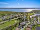 Scenic aerial shot showcasing a luxury community with golf course, several ponds, and waterfront views at 13783 Palmetto Point Ct, Port Charlotte, FL 33953
