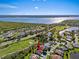 Aerial shot highlighting a home's location within a scenic waterfront, golf course community at 13783 Palmetto Point Ct, Port Charlotte, FL 33953