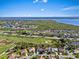 Picturesque aerial view of a waterfront community with lush greenery, a golf course, and stunning water views at 13783 Palmetto Point Ct, Port Charlotte, FL 33953