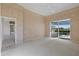 Spacious carpeted bedroom with sliding glass doors offering access to the pool area at 13783 Palmetto Point Ct, Port Charlotte, FL 33953