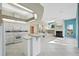 Bright kitchen featuring white cabinetry, tile flooring, and a center island with breakfast bar at 13783 Palmetto Point Ct, Port Charlotte, FL 33953