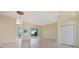 Bright living room featuring tile flooring, neutral walls, and sliding glass doors at 13783 Palmetto Point Ct, Port Charlotte, FL 33953