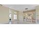 Open-concept living room with tiled floors, built-in shelves, and bright natural light at 13783 Palmetto Point Ct, Port Charlotte, FL 33953