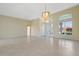 Large, bright living space with tile flooring, modern chandelier and high ceilings at 13783 Palmetto Point Ct, Port Charlotte, FL 33953