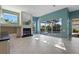 Spacious living room featuring tile floors, fireplace, and glass doors to the pool area at 13783 Palmetto Point Ct, Port Charlotte, FL 33953