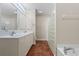Bathroom featuring double vanity, modern fixtures, glass block wall, and ceramic tile flooring at 143 Tropicana Dr # 1012, Punta Gorda, FL 33950
