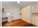 Bedroom includes wood floors, custom built-ins with storage and countertop desk, bright window and ceiling fan at 143 Tropicana Dr # 1012, Punta Gorda, FL 33950