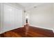 Bedroom with hardwood flooring and large closet; partial view of the kitchen at 143 Tropicana Dr # 1012, Punta Gorda, FL 33950