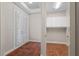 Spacious foyer with neutral walls, tile floor, built-in storage and French doors leading outside to let in natural light at 143 Tropicana Dr # 1012, Punta Gorda, FL 33950