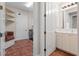 Laundry room with utility sink, cabinets, bench, and door to bathroom at 143 Tropicana Dr # 1012, Punta Gorda, FL 33950