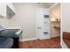 Bright laundry room with a modern washer and dryer, storage shelves, and an adjacent closet area at 143 Tropicana Dr # 1012, Punta Gorda, FL 33950