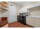 Laundry room with shelving, washer and dryer, and a utility sink and cabinets at 143 Tropicana Dr # 1012, Punta Gorda, FL 33950