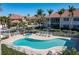 Community swimming pool and spa with ample lounge chairs for relaxing in a tropical setting at 143 Tropicana Dr # 1012, Punta Gorda, FL 33950