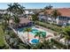 Community pool surrounded by lush tropical landscaping and a white fence, creating a serene oasis at 143 Tropicana Dr # 1012, Punta Gorda, FL 33950