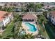 Aerial view of a resort-style pool with ample lounging space, surrounded by lush landscaping and beautiful condos at 143 Tropicana Dr # 1012, Punta Gorda, FL 33950