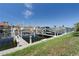 Picturesque view of a boat lift system along a waterfront property with lush landscaping and clear blue skies at 143 Tropicana Dr # 1012, Punta Gorda, FL 33950