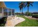 Landscaped backyard with tropical foliage and waterfront access at 1435 Pine Island Ct, Punta Gorda, FL 33950