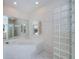 Bathroom featuring tile floor, glass block accent, soaking tub and large mirror at 1435 Pine Island Ct, Punta Gorda, FL 33950