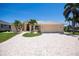 A home exterior shows a well-manicured lawn, brick driveway, and a two car garage at 1435 Pine Island Ct, Punta Gorda, FL 33950