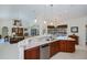 Open kitchen with wood cabinets, granite countertops, and white tile flooring at 1435 Pine Island Ct, Punta Gorda, FL 33950