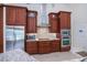 Close-up of a kitchen with wood cabinets, stainless steel appliances and granite countertops at 1435 Pine Island Ct, Punta Gorda, FL 33950