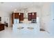 Bright kitchen with white tile floors, breakfast bar with seating, stainless appliances, and granite countertops at 1435 Pine Island Ct, Punta Gorda, FL 33950