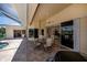 Covered patio with a table and chairs, and a grill for outdoor cooking at 1435 Pine Island Ct, Punta Gorda, FL 33950