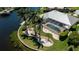 Aerial view of a screened-in pool and lush landscaping in a waterfront backyard at 1435 Pine Island Ct, Punta Gorda, FL 33950