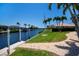Waterfront property featuring meticulously kept lawn and landscaping at 1435 Pine Island Ct, Punta Gorda, FL 33950
