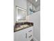 Contemporary bathroom vanity with a black marble countertop, modern mirror, and glass shower at 15 Tournament Rd, Rotonda West, FL 33947