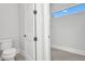 Neutral powder room with a white toilet and modern fixtures at 15 Tournament Rd, Rotonda West, FL 33947