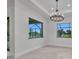 Bright dining room with large windows offering views of the outdoors at 15 Tournament Rd, Rotonda West, FL 33947