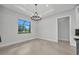 Bright dining room with large windows and modern chandelier at 15 Tournament Rd, Rotonda West, FL 33947