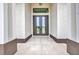 Grand entrance featuring double glass doors and travertine floors at 15 Tournament Rd, Rotonda West, FL 33947