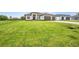 A modern one-story home has well-manicured front lawn at 15 Tournament Rd, Rotonda West, FL 33947