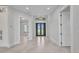 Bright foyer with decorative light fixture, tile flooring and views to the front door at 15 Tournament Rd, Rotonda West, FL 33947