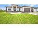 Stunning single-story home featuring a three-car garage and well-kept lawn at 15 Tournament Rd, Rotonda West, FL 33947