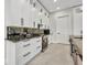 Modern kitchen features white cabinets, black hardware, and granite countertops at 15 Tournament Rd, Rotonda West, FL 33947