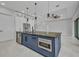 Gourmet kitchen island with stainless steel appliances and custom cabinetry at 15 Tournament Rd, Rotonda West, FL 33947