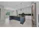 Modern kitchen featuring a large island with a dark countertop and stainless appliances at 15 Tournament Rd, Rotonda West, FL 33947