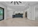 Open-concept kitchen with a dark island, tile floors, and modern appliances at 15 Tournament Rd, Rotonda West, FL 33947