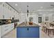 Open-concept kitchen with blue island, marble countertops, and modern appliances at 15 Tournament Rd, Rotonda West, FL 33947
